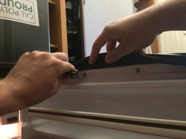 Repairing refrigerator leaking water by replacing the door gasket